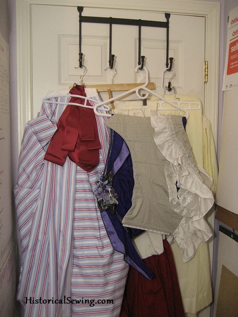 Storing costumes on hooks behind the door