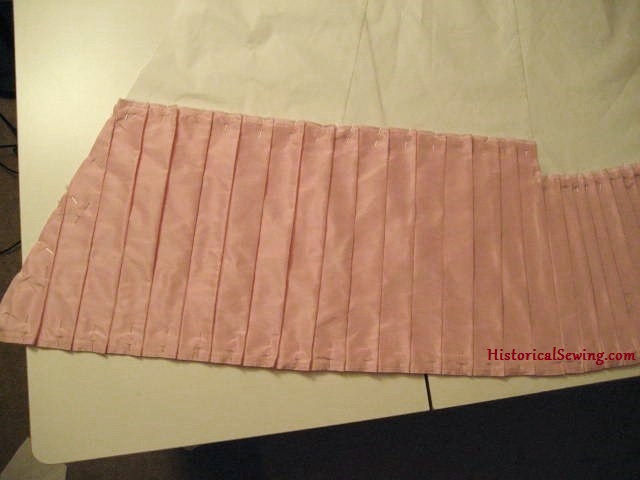 Pleats pinned into skirt seam edge