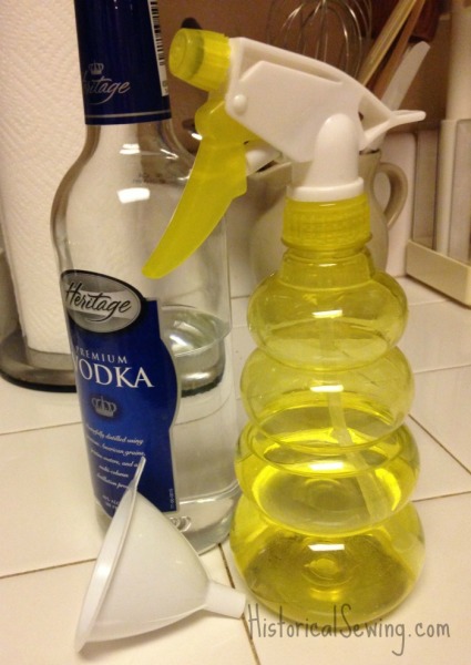 Pour vodka into spray bottle using a funnel
